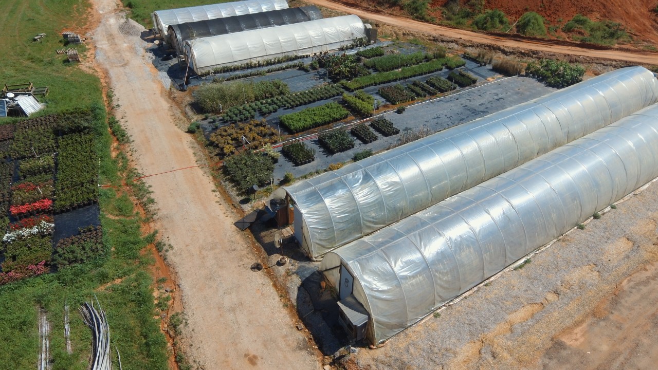 Shade structures covering seasonal flowers and shrubs.
